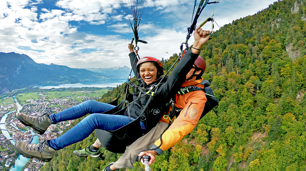 Student Srishti Srivastava paraglides over the Swiss Alps while studying abroad.